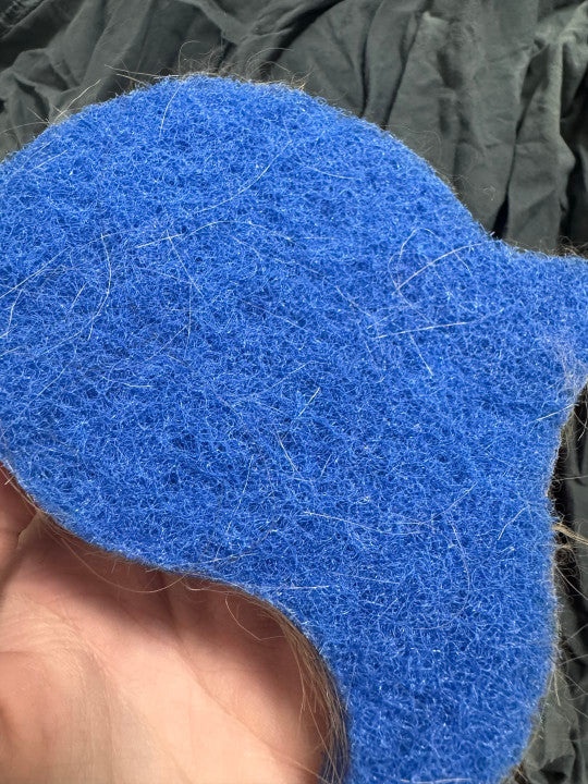 Customer review showing blue laundry pet hair remover with collected hair