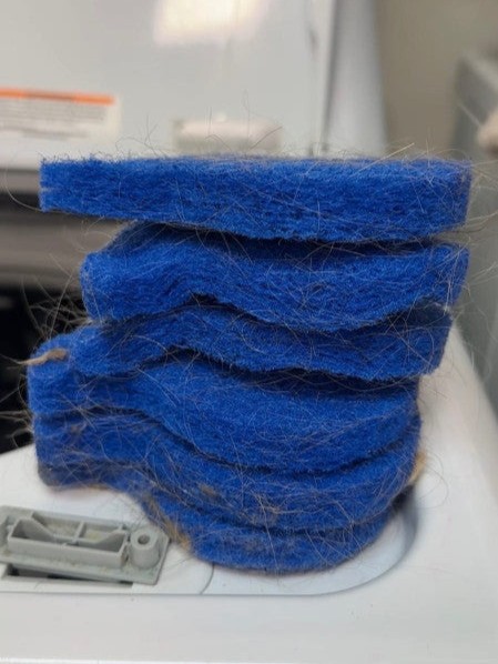 Customer review showing stacked blue laundry pet hair remover pads